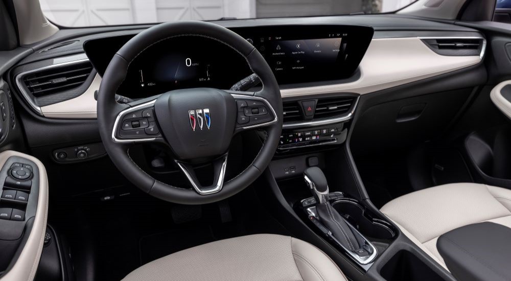 The black and white interior and dash of a 2024 Buick Encore GX Avenir is shown.