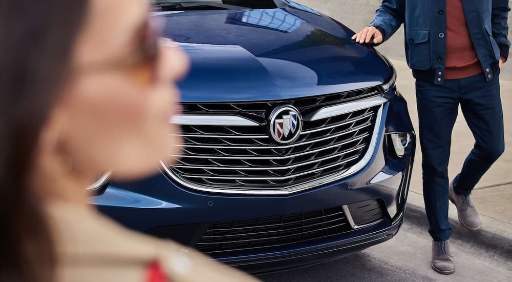 A close-up on the hood of a blue 2024 Buick Enclave.