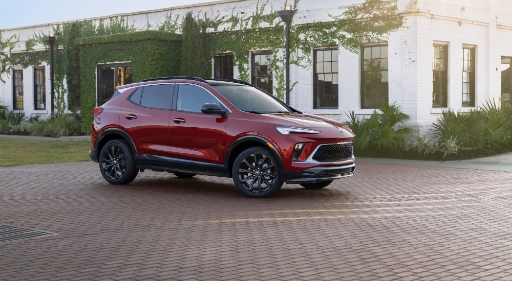 A red 2025 Buick Encore GX for sale is shown from the side.