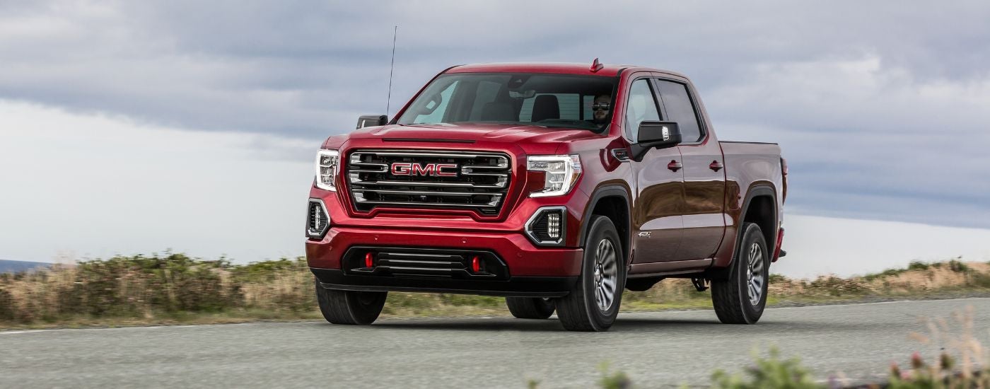 Red 2019 GMC Sierra 1500 AT4 parked on a driveway.