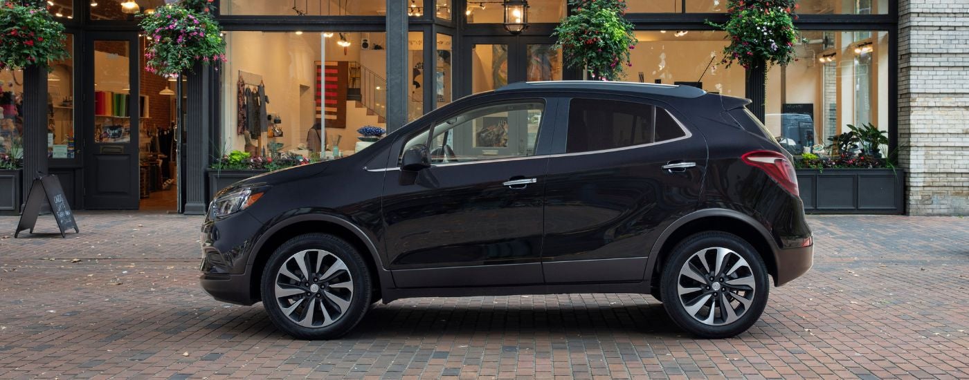 Black 2022 Buick Encore driving down a street.