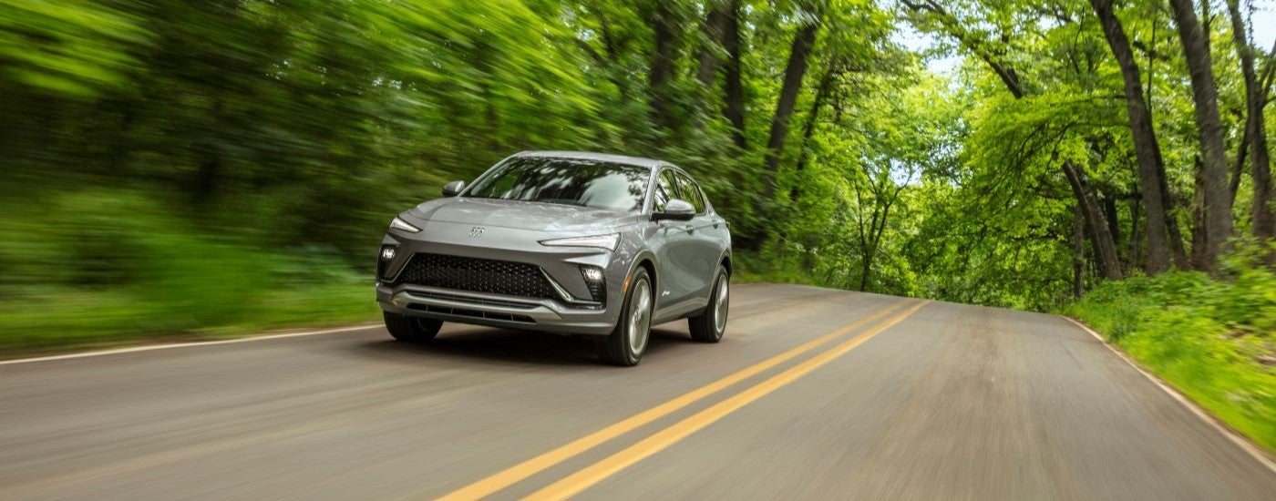 Grey 2024 Buick Envista Avenir driving down a road.