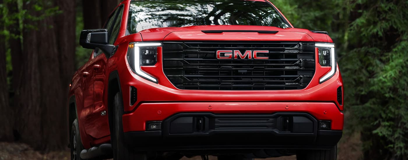 Close-up on the grille of a red 2026 GMC Sierra 1500.