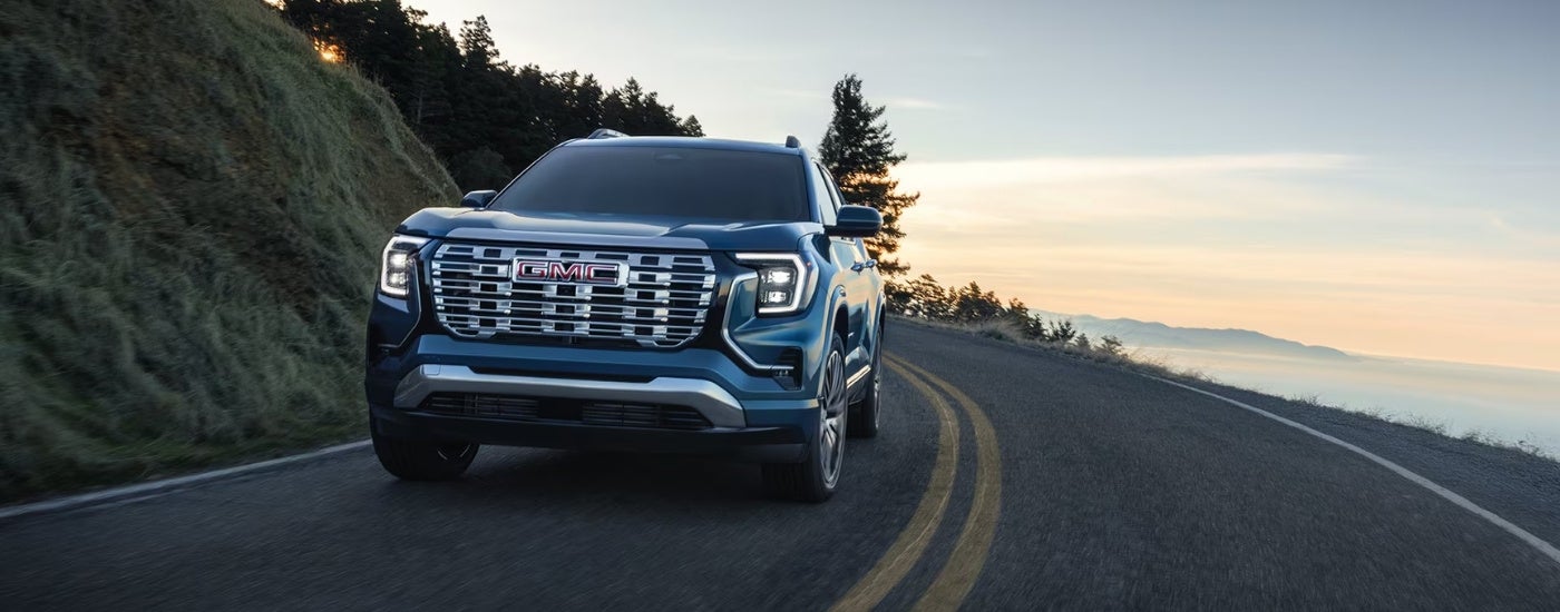 Blue 2026 GMC Terrain Denali rounding a corner