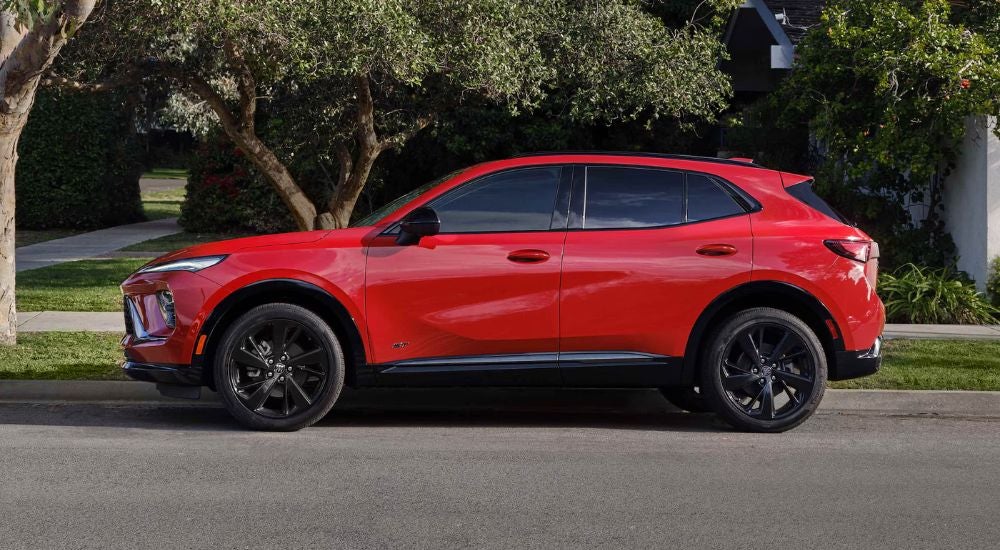Red 2026 Buick Envision ST from the side on a road.