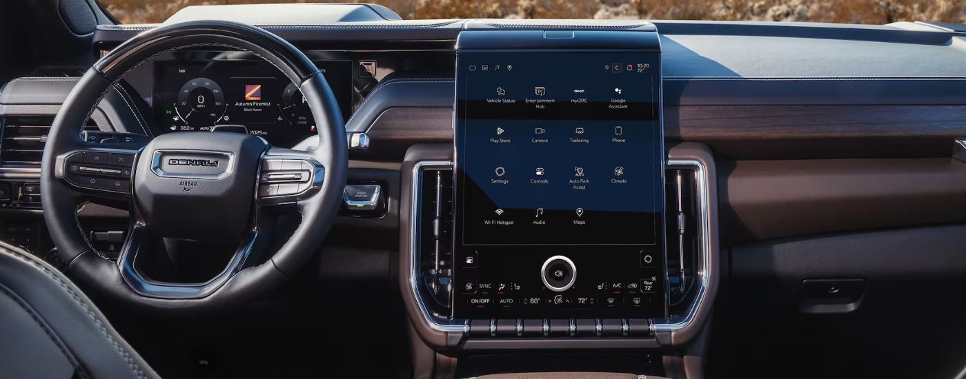 2026 GMC Yukon Front Interior with steering wheel and infotainment screen.
