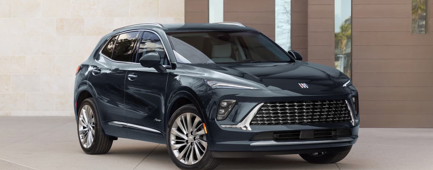 Black 2026 Buick Envision parked in front of a wall. 