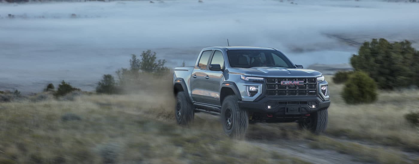A grey 2025 GMC Canyon AT4x AEV from the front after leaving a GMC dealer near Bath Township.