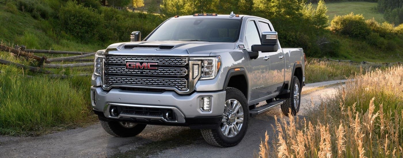 A silver 2021 GMC Sierra 2500HD Denali is shown parked on a trail.