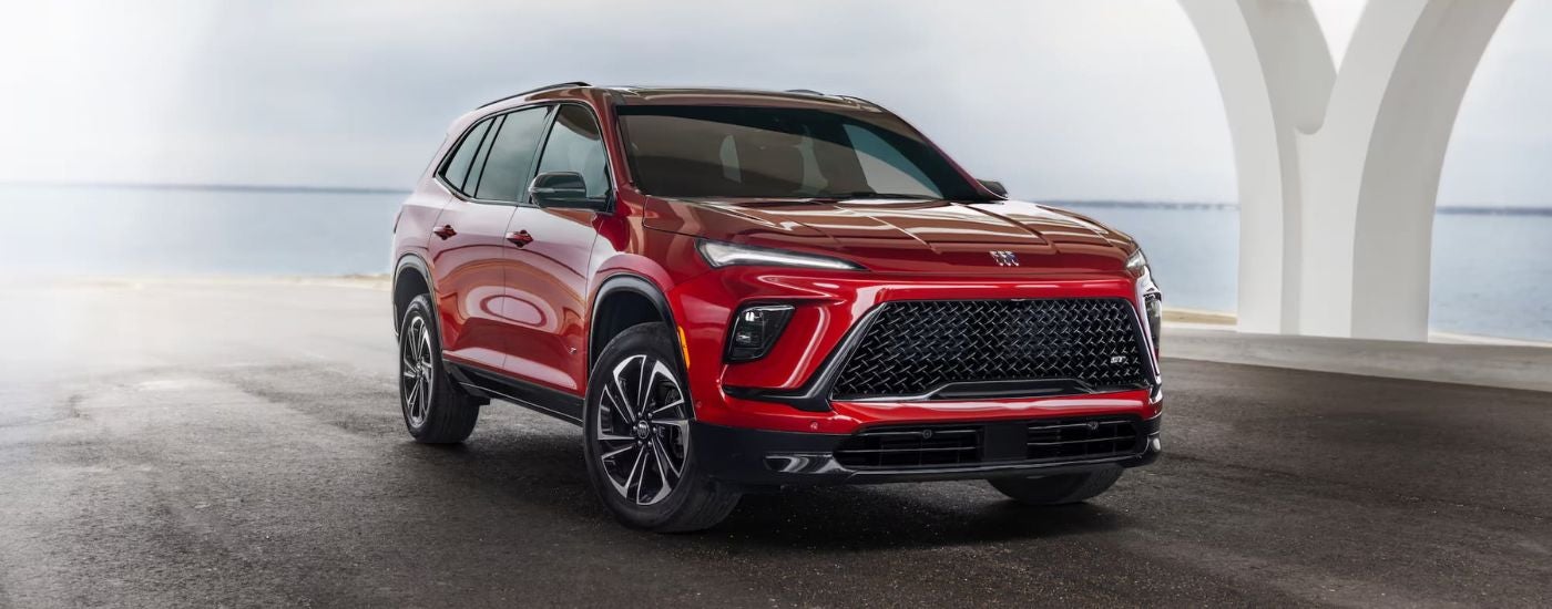 A red 2025 Buick Enclave ST parked on a bridge
