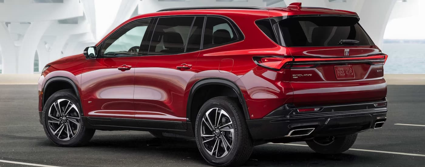 A red 2025 Buick Enclave parked in a parking garage