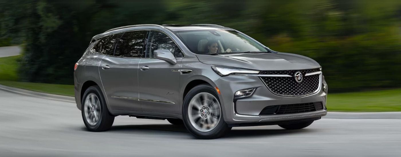 A gray 2024 Buick Enclave Avenir is shown parked.